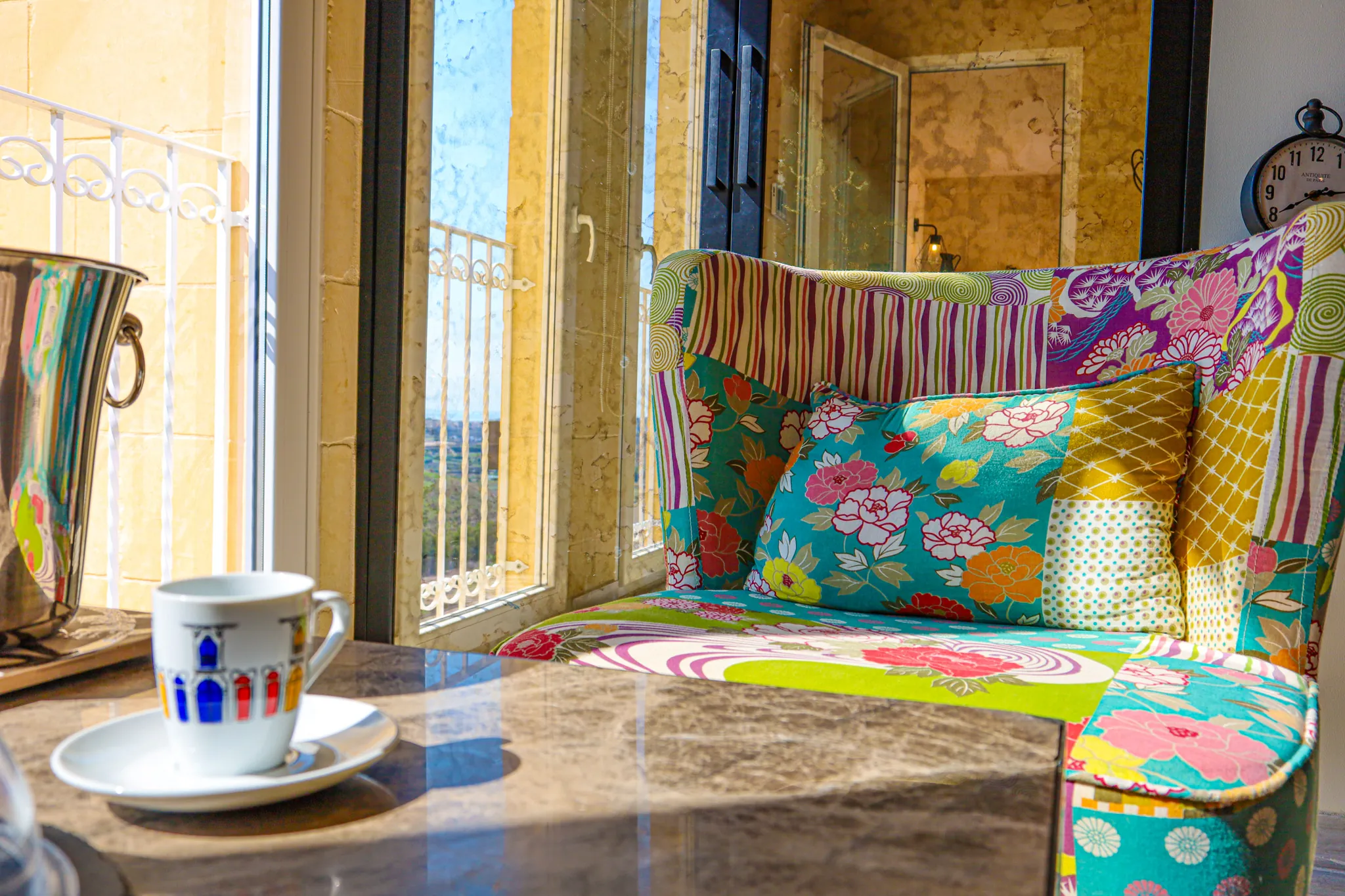A patterned armchair by a tall window in a character home